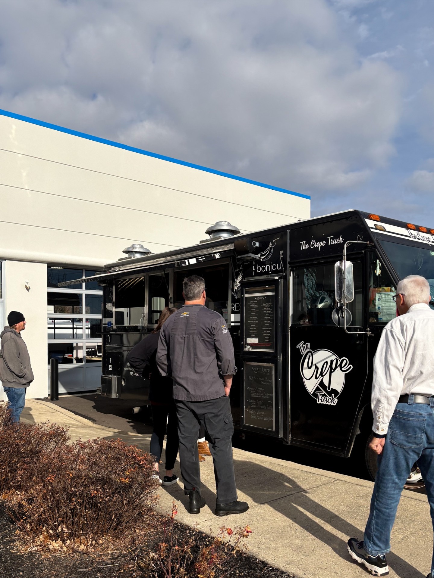 The Crepe Truck parked at Patriot Chevrolet with team members grabbing lunch