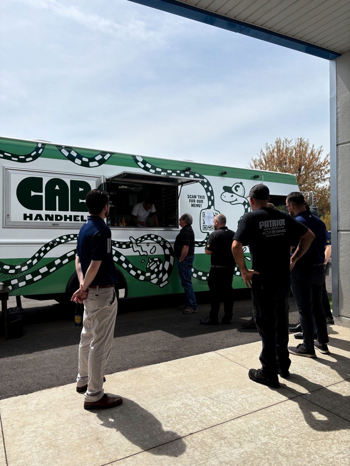 Patriot Dealerships team lined up for the CAB Handhelds food truck on Food Truck Friday